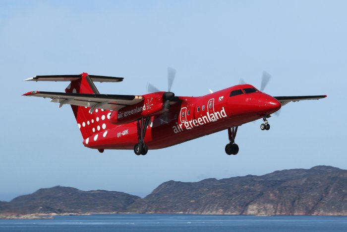 A red turbo prop plane lands in Greenland.