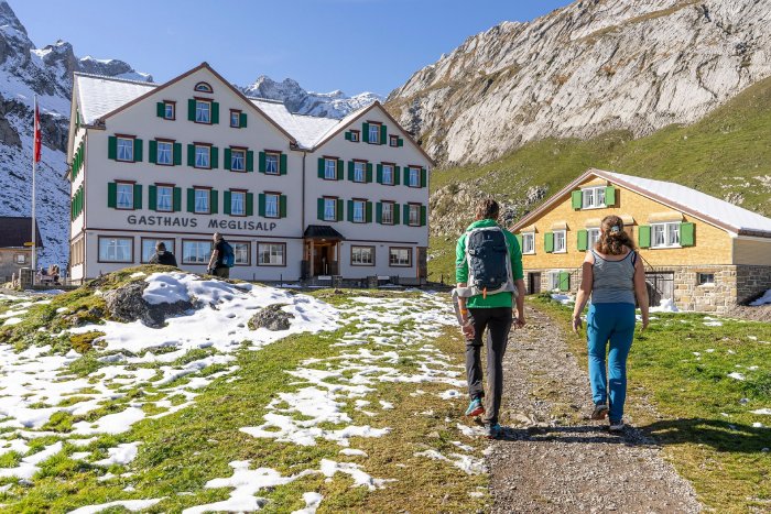 An Alpine hostel greets hikers in Switzerland on a sunny late spring day. 