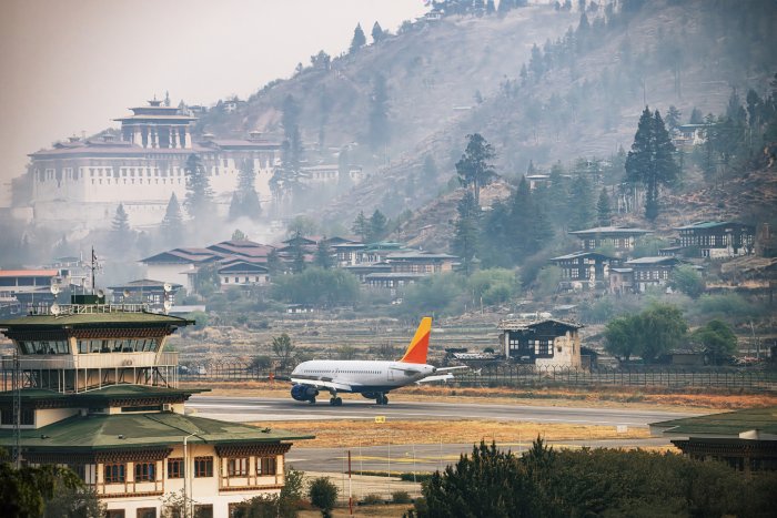 An airplane lands at Bhutan's Paro International Airport.