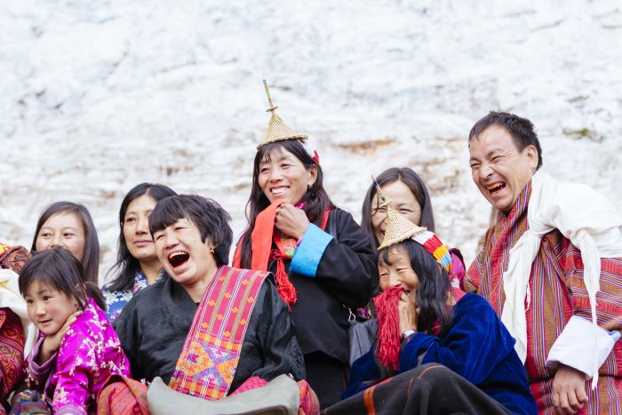 Bhutanese watch dancers performing in the courtyard of the Gasa Dzong at the annual Gasa Tshechu festival.