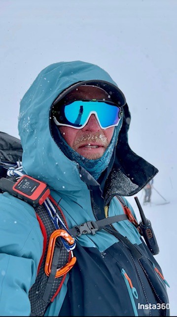 Jason Howell selfie wearing sunglasses, a jacket and climbing gear.