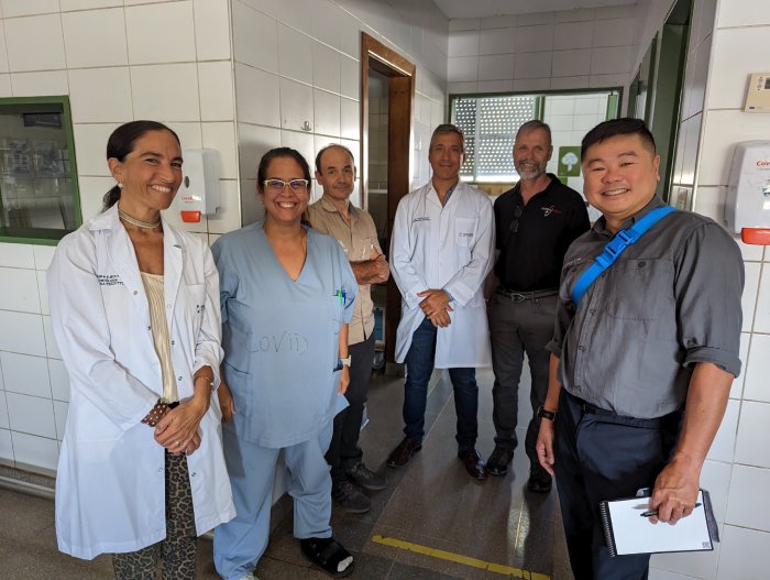 A team of medical staff at a clinic, posing for a photograph.