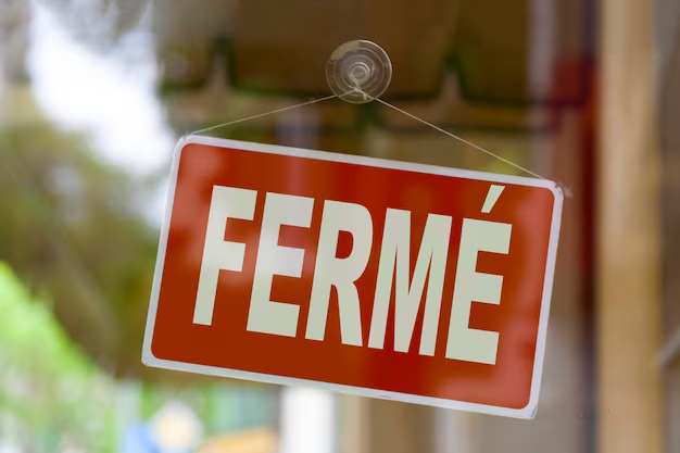 A Ferme sign hangs in a shop window. 