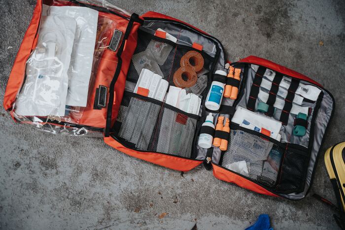 A well-stocked first-aid kit lies open.
