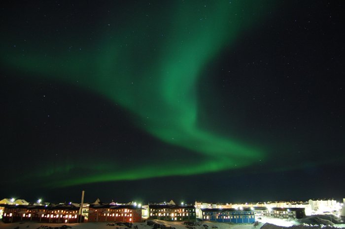 The northern lights as seen from a small city in Greenland.