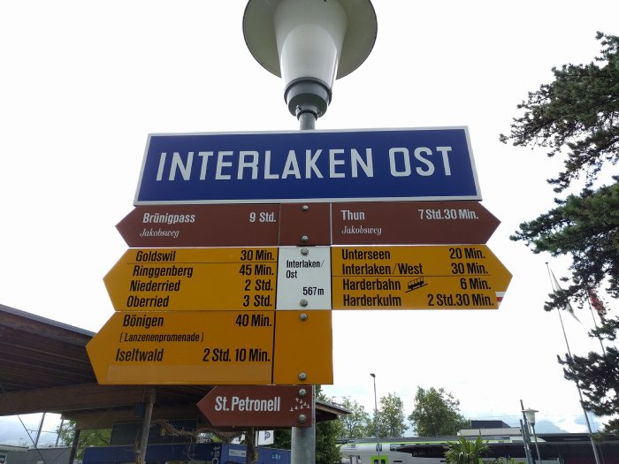 Street signs point to different local destinations near Interlaken, Switzerland.