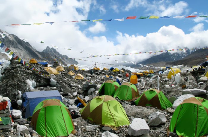 Green tents and prayer flags at the Mera high base camp in Nepal.