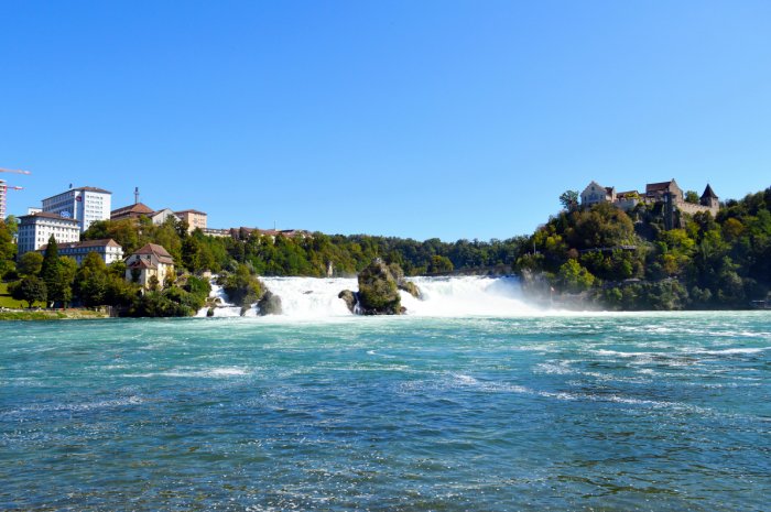 A massive waterfall in Switzerland on a sunny summer day.