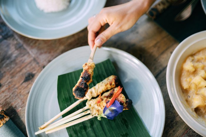 Satay chicken on a skewer.