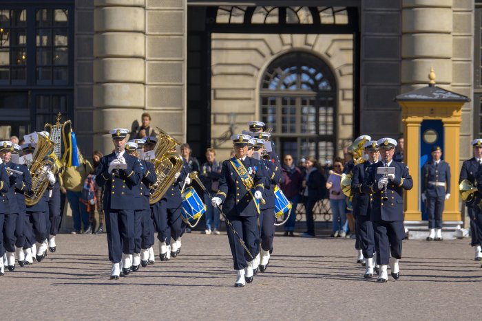 A marching band plays in front of a castle in Stockholm, Sweden.