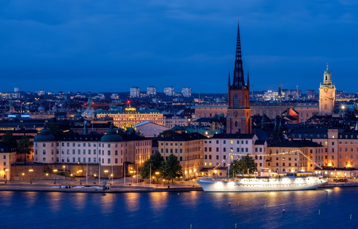 Stockholm, Sweden, at night, with a ship in the foreground.