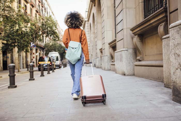 Rear view of a young African American woman on vacation arriving to Barcelona.