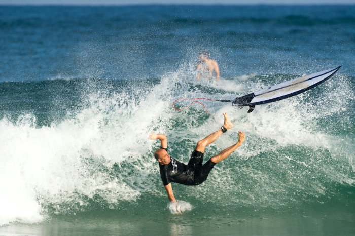 A surfer wipeout's in the water.