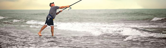 A man surfcasts on a beach in Galveston, Texas.