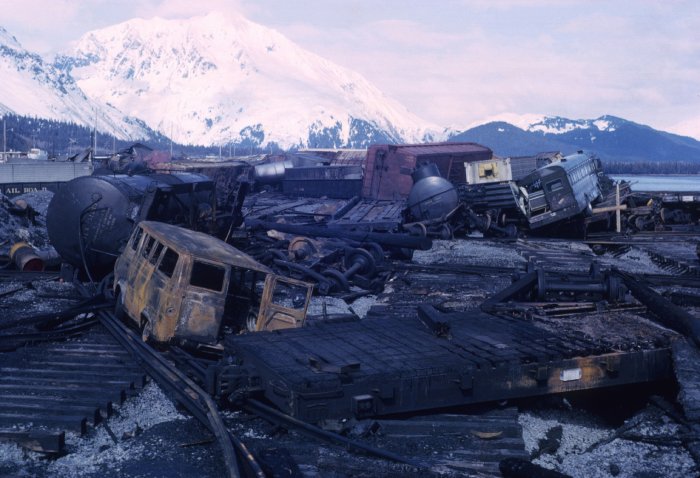 Vans, buses, and train car wreckage after an earthquake in Alaska.