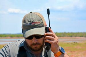 A Global Rescue operations team members uses his satellite phone for a call from out in the field.