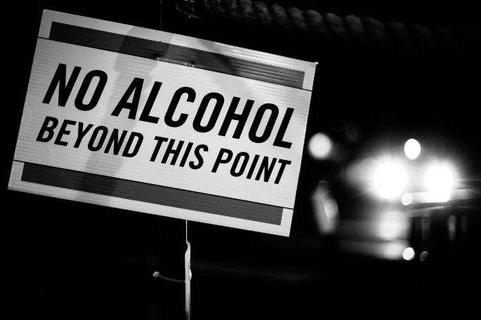A black and white image of a sign that reads No Alcohol Beyond This Point