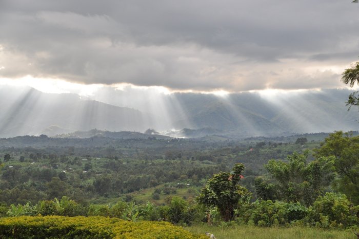 Sunrays beam through the clouds over the Rwenzori Mountains of Congo. 